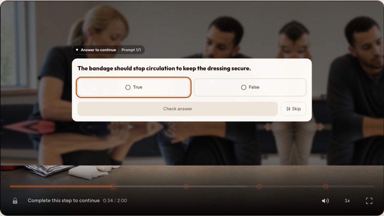 A real Interakly true-or-false knowledge check centered over a first-aid training video
